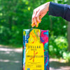 An image of a hand reaching into Stellar Snacks' 16 ounce Simply Stellar pretzels
